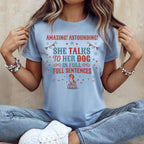 Light blue t-shirt with "She talks to her dog in full sentences" text.