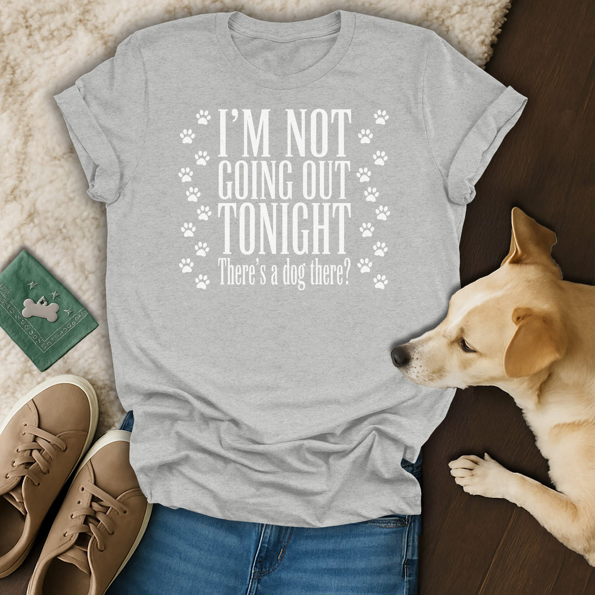 Grey t-shirt with white text "I'M NOT GOING OUT TONIGHT There's a dog there?" and paw prints.