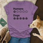 Purple t-shirt with "Humans 1/5 stars, Dogs 5/5 stars" text and paw prints.