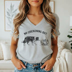 Gray t-shirt with black line art of a border collie facing chickens and text "NO CHICKENING OUT."