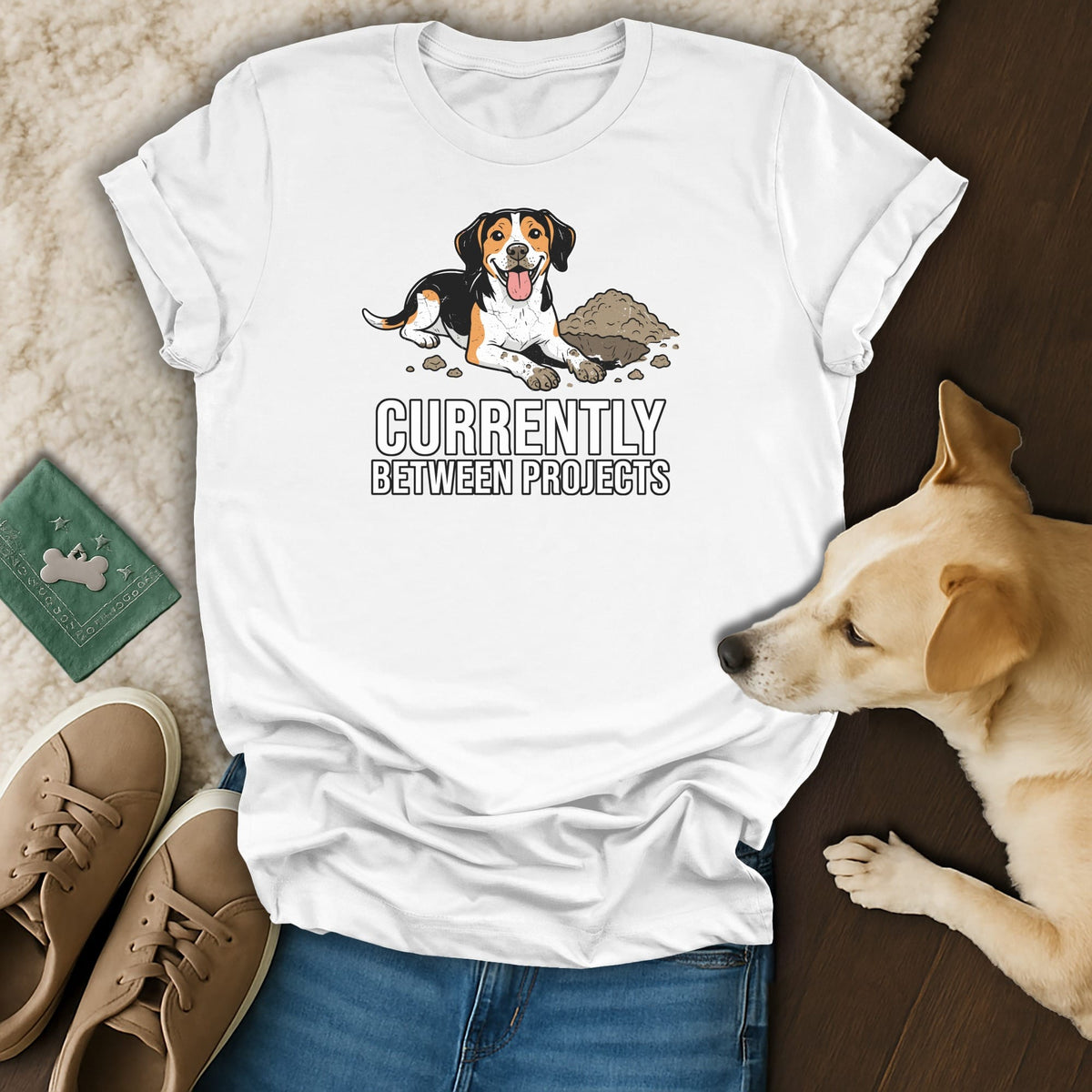 White t-shirt with a beagle dog and dirt graphic, text "Currently Between Projects".