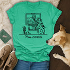 Bulldog painting a landscape on easel, text "Paw-casso".