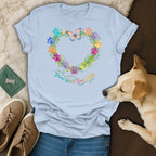 Light blue t-shirt with colorful paw print heart graphic and quote "Grow Wild, Love Dogs".