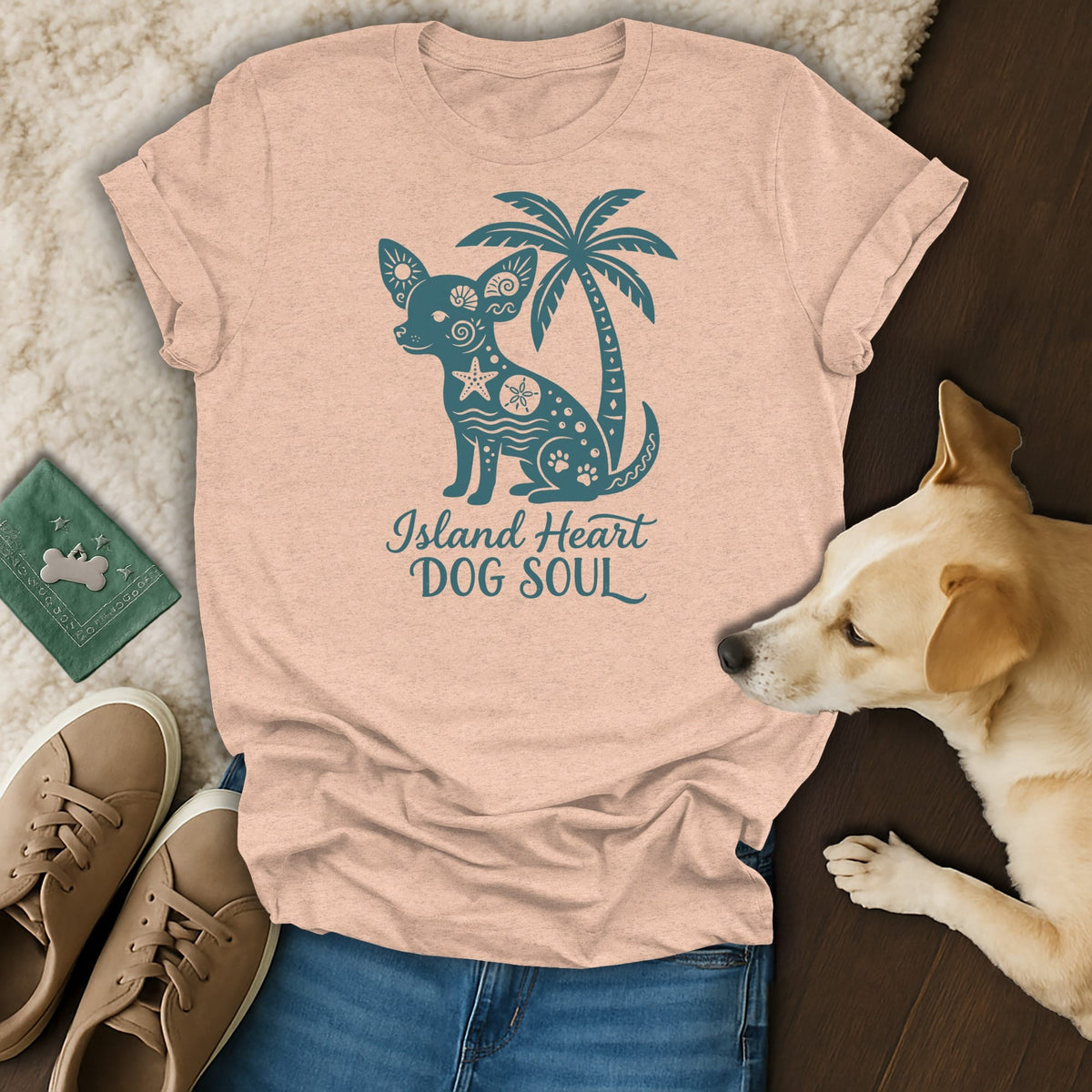 Peach t-shirt with teal graphic of dog, palm tree, and text "Island Heart DOG SOUL".
