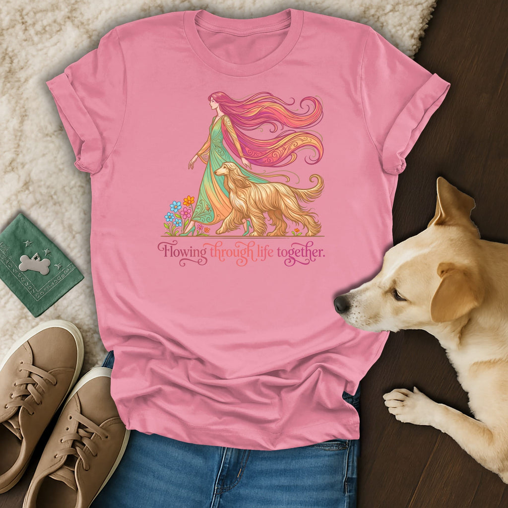Pink t-shirt with a woman and dog illustration, text "Flowing through life together."