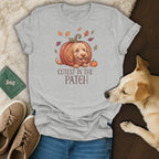 Light grey t-shirt with a doodle dog in a pumpkin and "Cutest in the Patch" text.