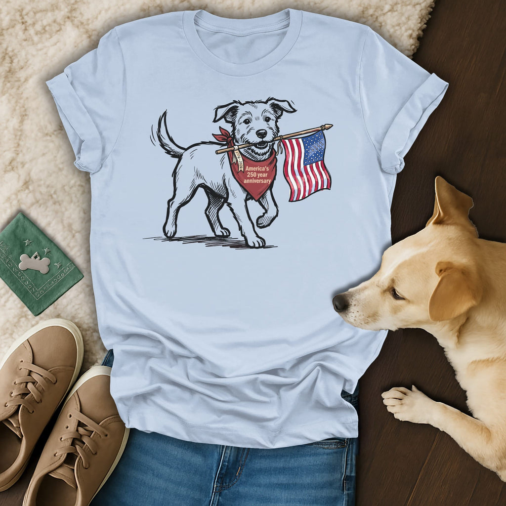 Dog wearing bandana, holding American flag in mouth, on t-shirt.