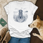 T-shirt with a surfing dog wearing a lei, tropical scene on the water.
