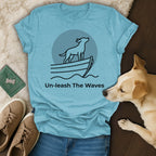 Light blue t-shirt with a dog on a boat and text "Un-leash The Waves".