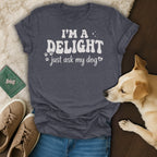 Dark grey t-shirt with "I'M A DELIGHT just ask my dog" in white text.
