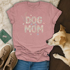 Pink t-shirt with "DOG MOM" text made of shells and paw prints.