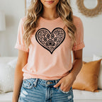 Peach t-shirt with heart containing paw print and decorative elements.