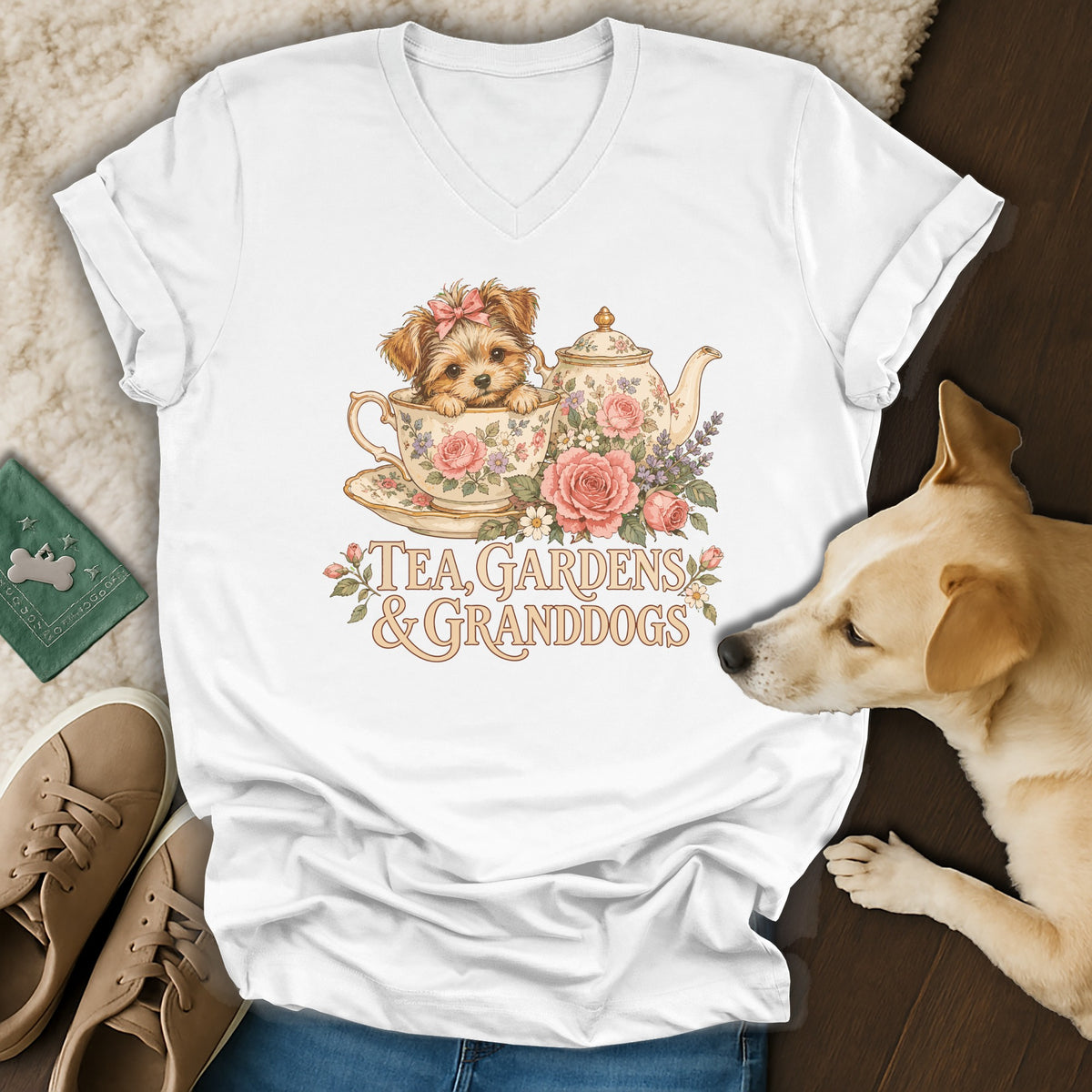A white v-neck t-shirt displays a vintage illustration of a puppy in a teacup with flowers and text reading Tea Gardens and Granddogs.