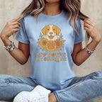 Light blue t-shirt with graphic of dog, sunflowers, paw print, and text "My Dog Is My Sunshine".