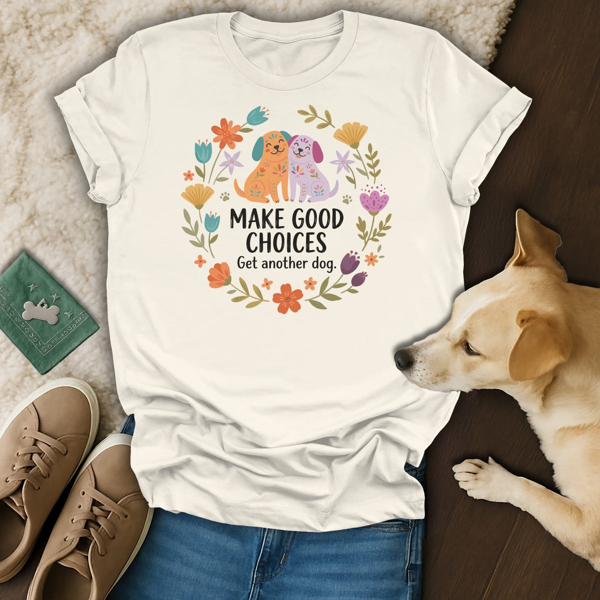 White t-shirt with floral design, two dogs, and text "MAKE GOOD CHOICES Get another dog."