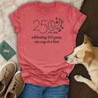 Red t-shirt with "250 one wag at a time" text and paw prints.