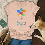 T-shirt with colorful paw print balloons and text "dogs keep us afloat."