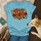 Light blue t-shirt with "My Dog Owns Me" text inside a heart and banner.