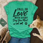 Green t-shirt with "Fall in Love With Every Dog You Meet" text and dog silhouettes.