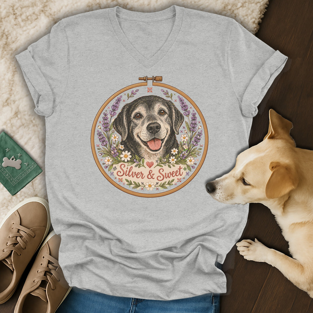 Heather gray v-neck t-shirt featuring an embroidered hoop graphic of a black dog surrounded by flowers and the text Silver & Sweet.
