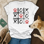 White t-shirt with a tic-tac-toe grid design featuring red paw prints.
