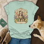 Light green graphic t-shirt with an illustration of a senior dog surrounded by flowers and text.