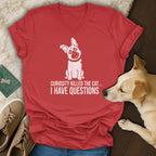 Red t-shirt with a white cartoon dog and text "Curiosity killed the cat... I have questions".