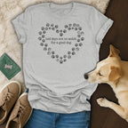 Grey t-shirt with a heart made of paw prints and text "bad days are no match for a good dog."