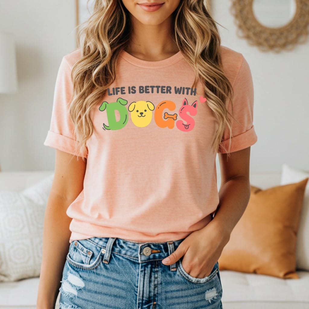 Peach t-shirt with colorful "DOGS" graphic and text "LIFE IS BETTER WITH DOGS".