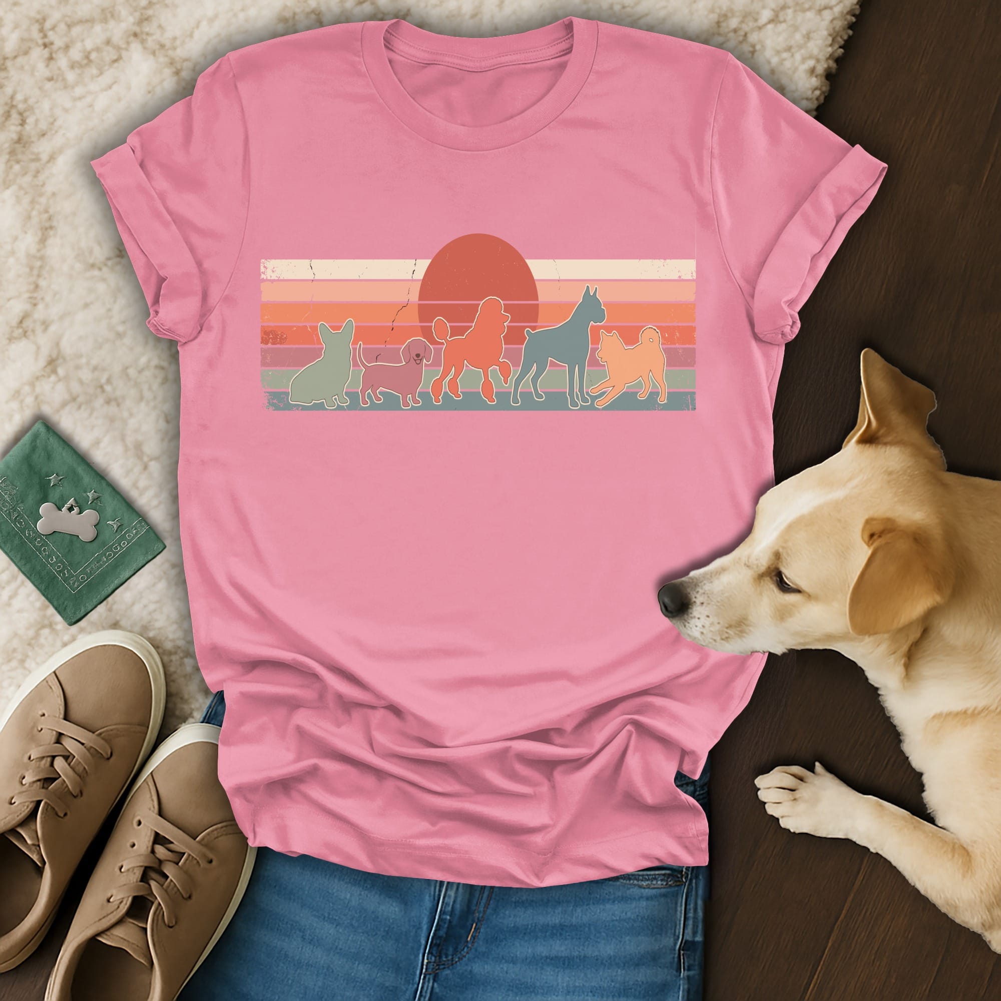 Pink t-shirt with silhouette dogs against a retro sunset graphic.