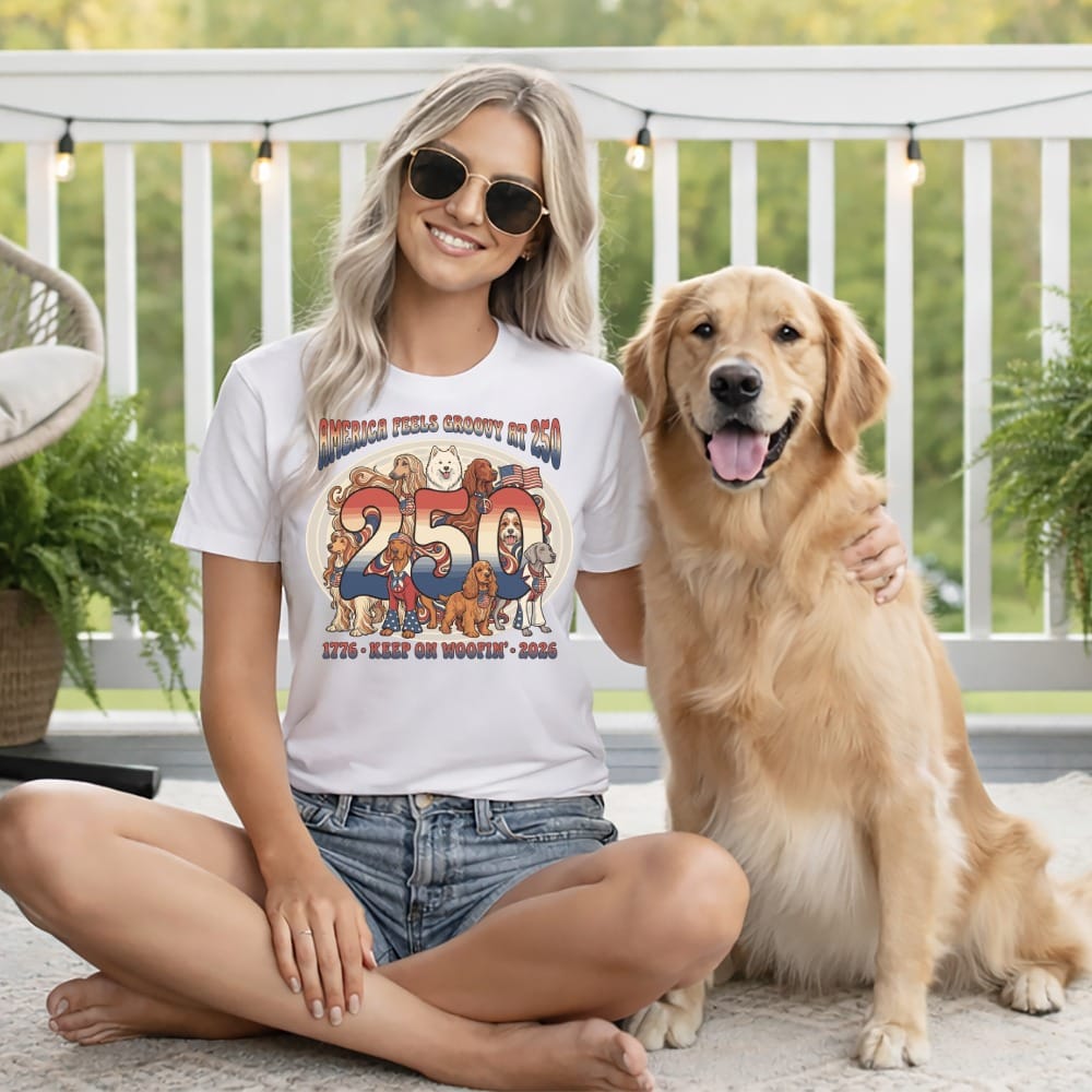Woman with golden retriever wearing "America Feels Groovy" dog graphic t-shirt.