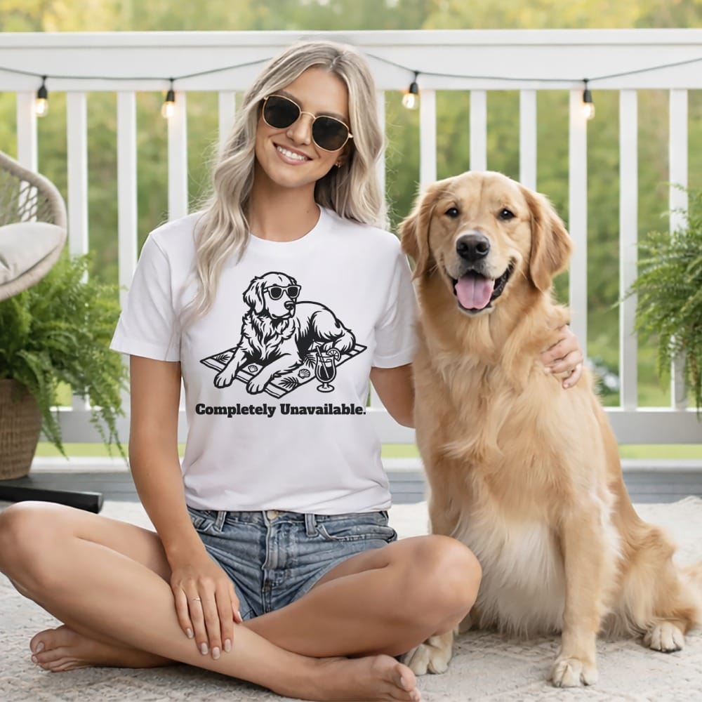 Woman wearing a t-shirt with a dog graphic and text, sitting with a golden retriever.