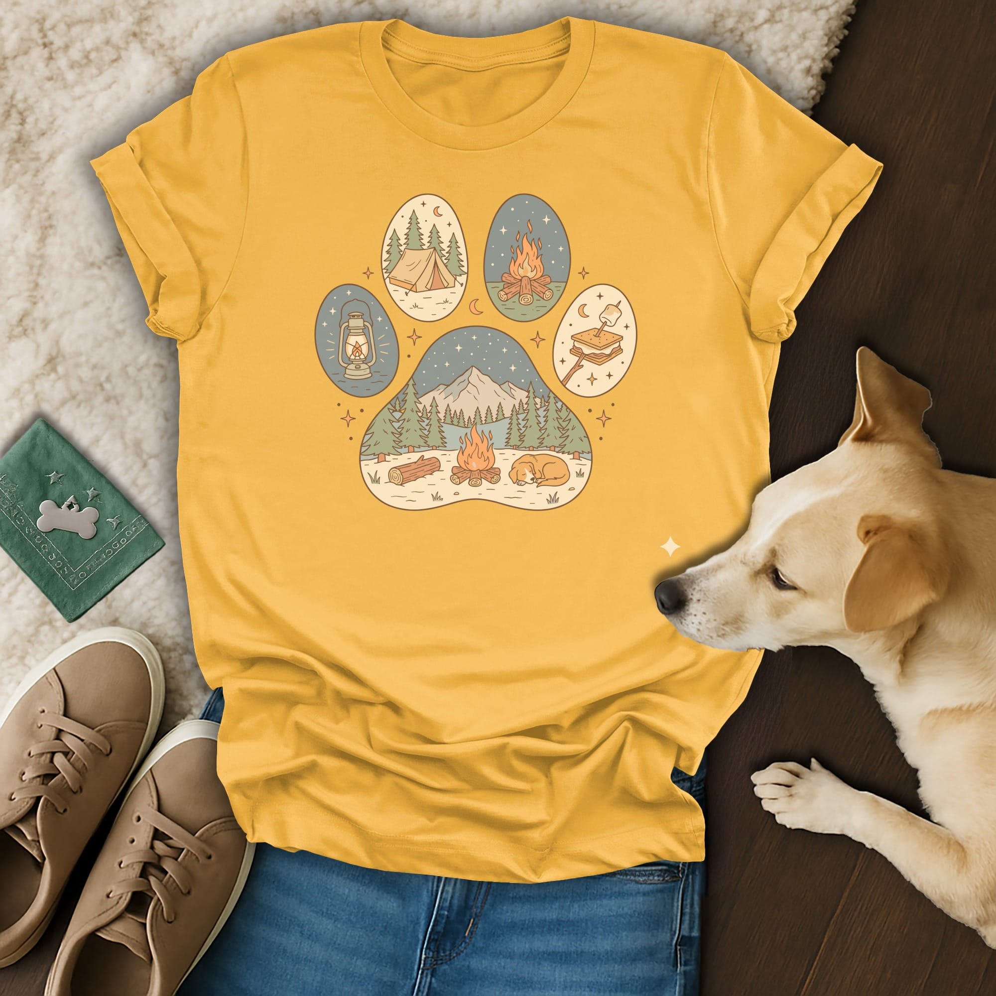 Yellow t-shirt with paw print design featuring camping scenes and a dog.