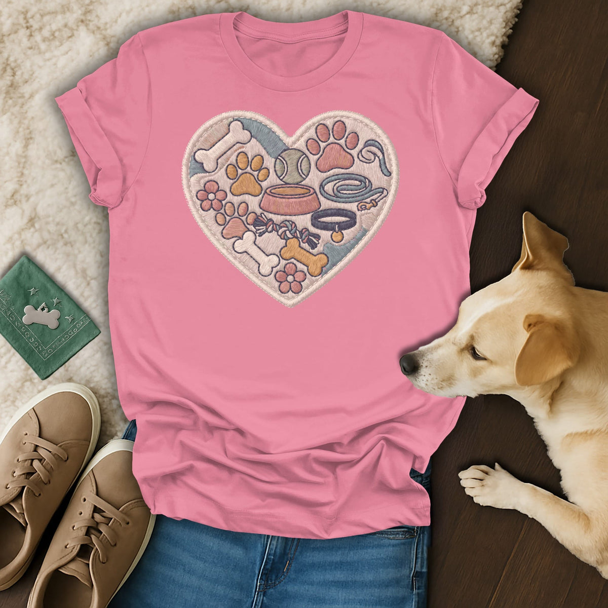 Pink t-shirt with embroidered heart filled with dog toys and paws.