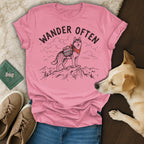 Pink t-shirt with a husky illustration and "WANDER OFTEN" text.