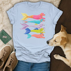 Light blue t-shirt with colorful dog-mermaid designs and a yellow lab dog.