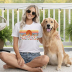 Woman wearing a dog-themed t-shirt with a golden retriever.