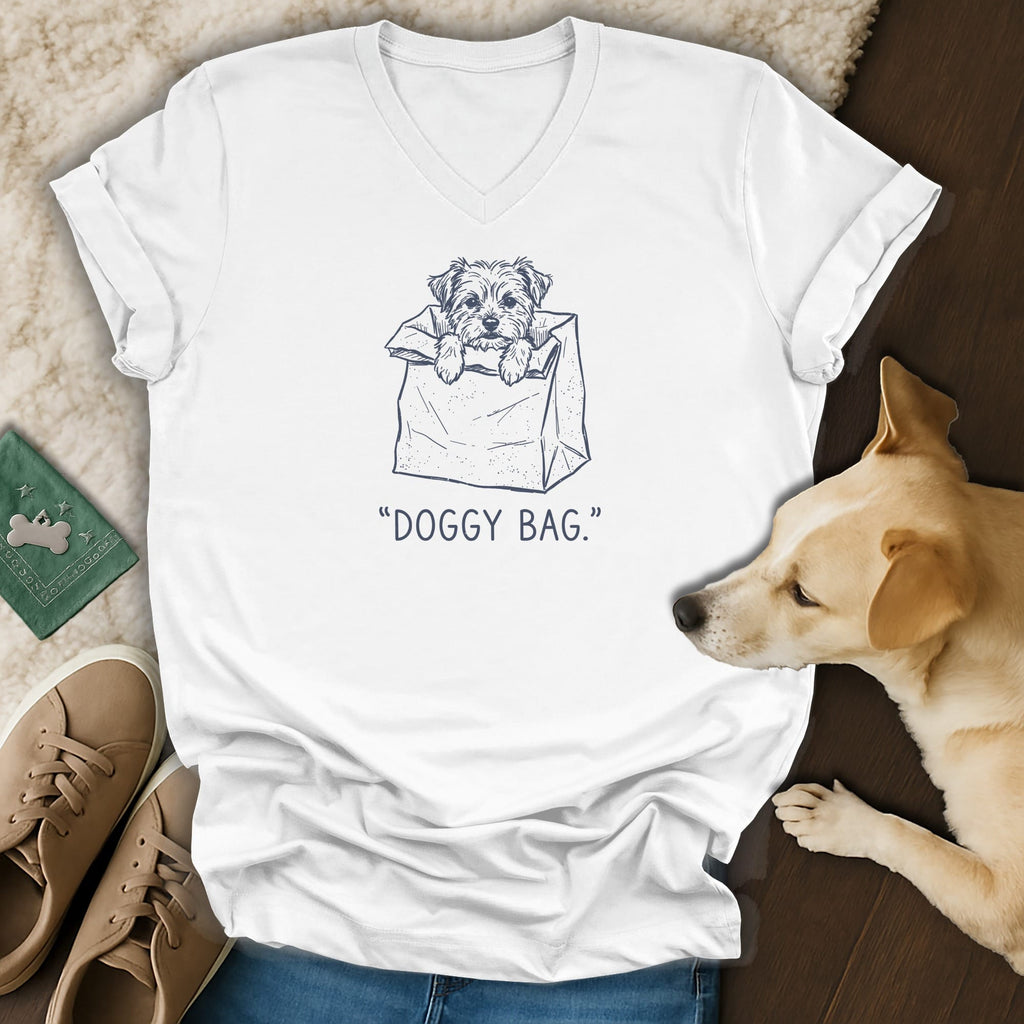 White v-neck t-shirt with a sketch of a dog in a paper bag.