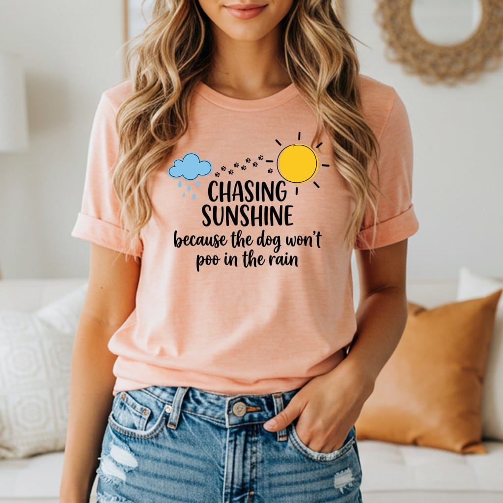 Peach t-shirt with "Chasing Sunshine Because The Dog Won't Poo In The Rain" text.