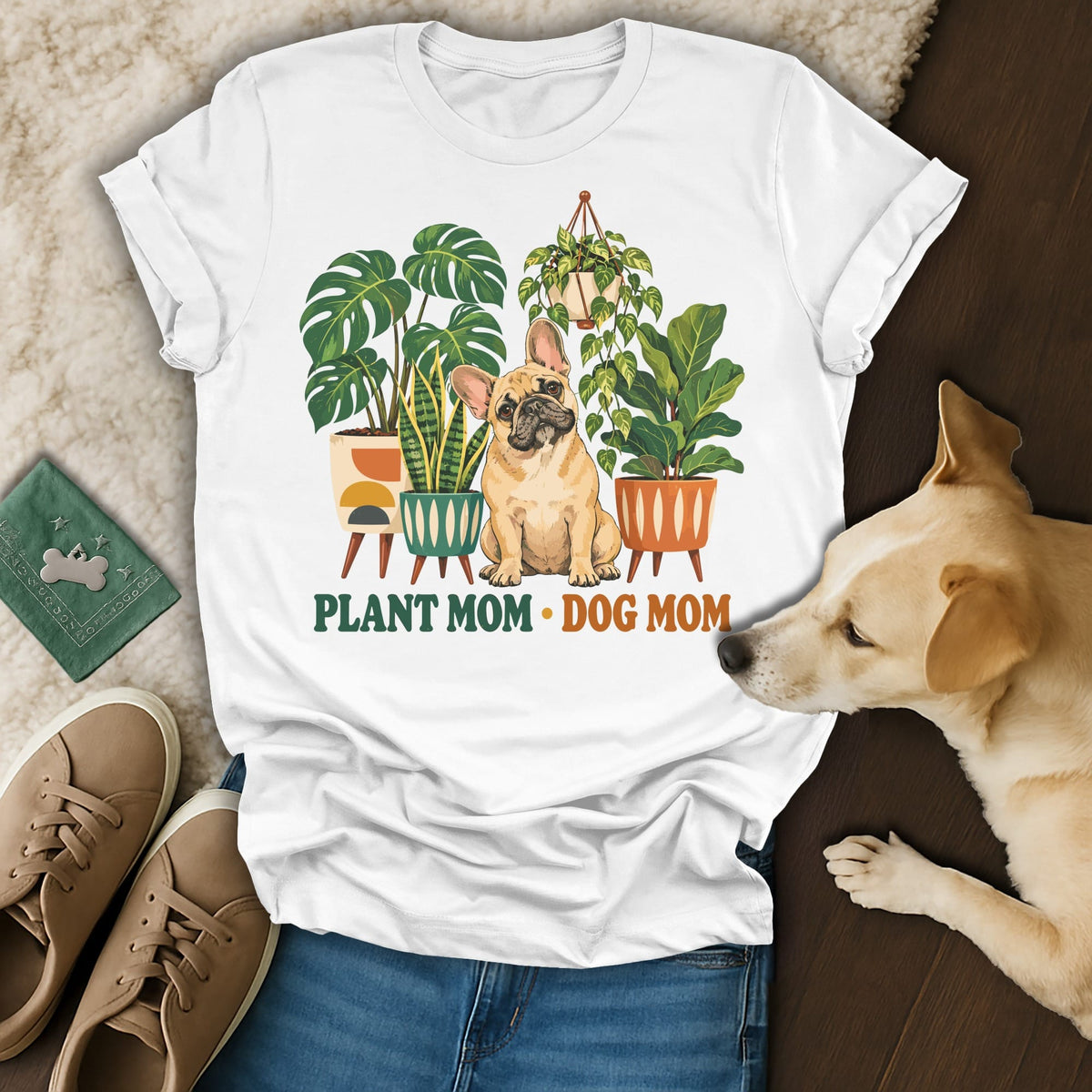 White t-shirt featuring a French bulldog surrounded by potted plants and the text Plant Mom Dog Mom.