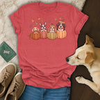 T-shirt with four cartoon dogs in pumpkins and falling leaves design.