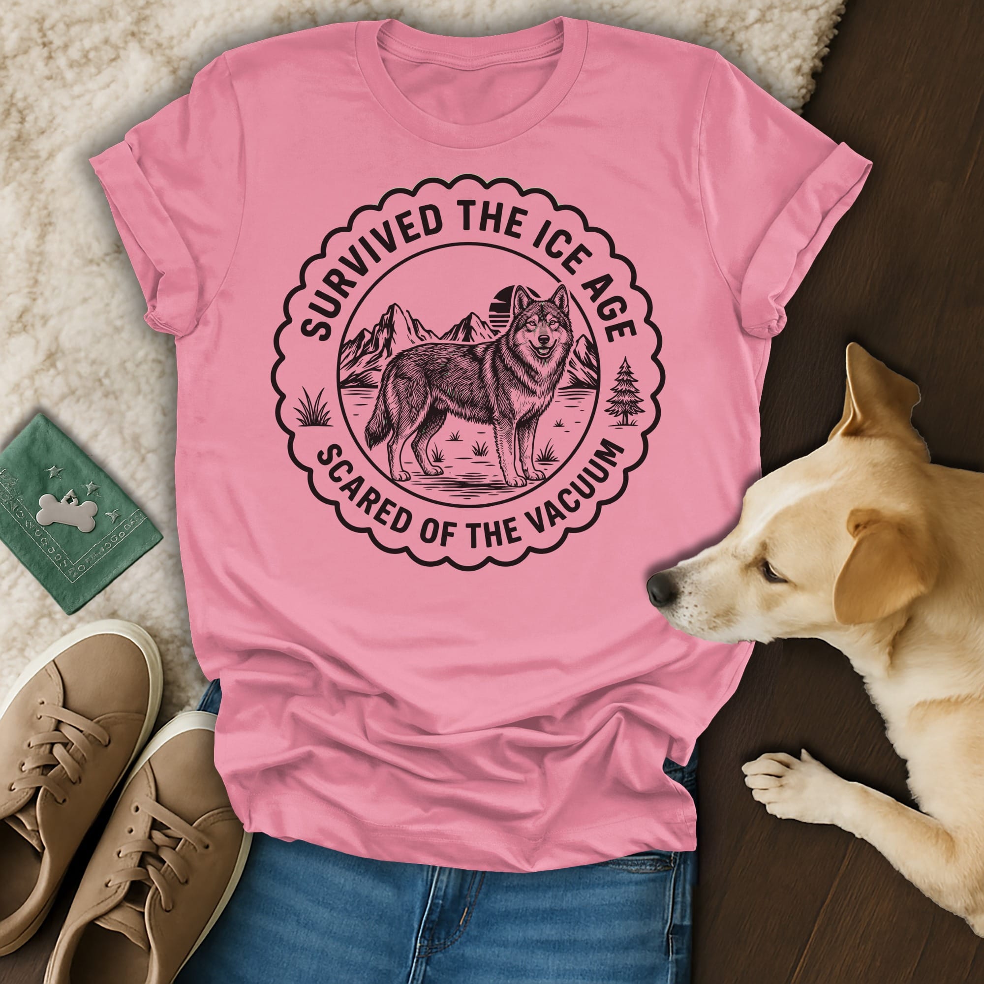 Pink t-shirt with "Survived the Ice Age Scared of the Vacuum" and wolf graphic.
