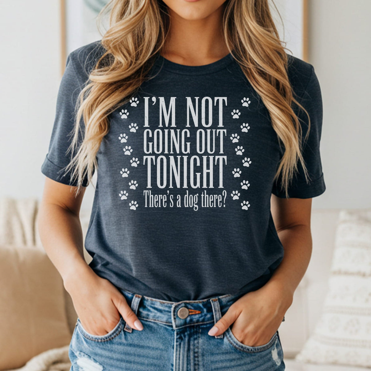 Dark t-shirt with white text "I'M NOT GOING OUT TONIGHT" and paw prints.