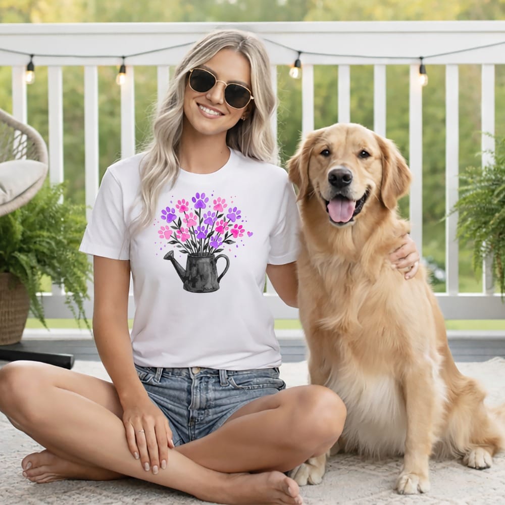 Woman with golden retriever wearing a t-shirt with flower bouquet and watering can.