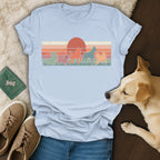 Lineup of dogs in retro style with sunset graphic on light blue t-shirt.