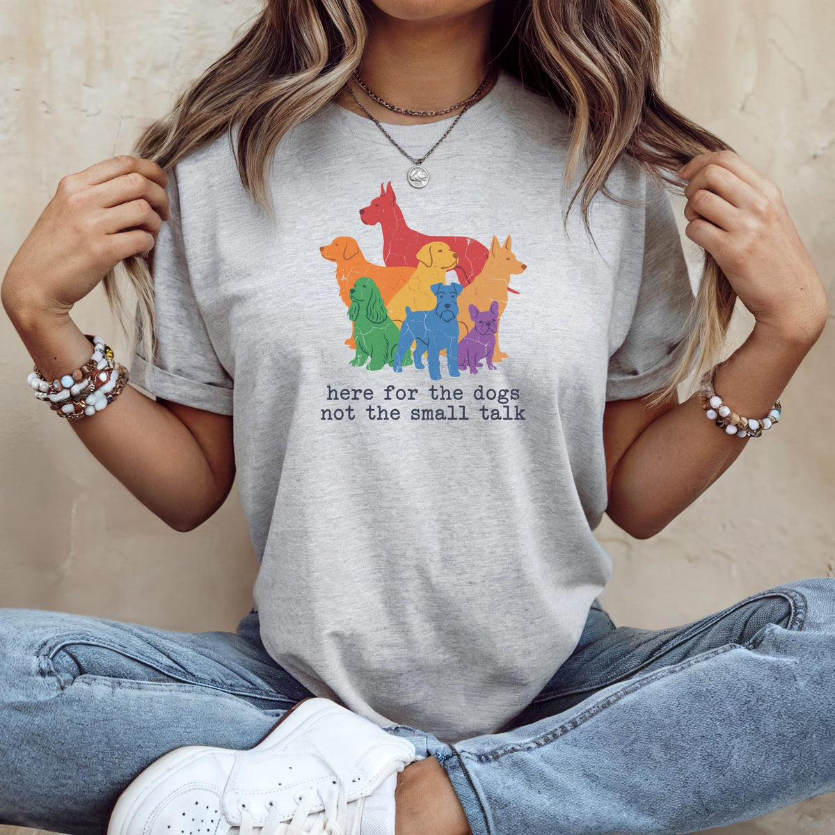 Grey t-shirt with colorful dog illustration and text "here for the dogs not the small talk".
