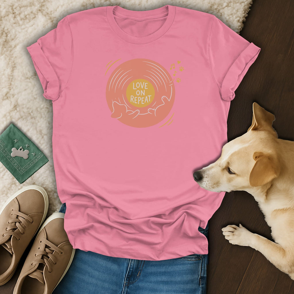 A pink t-shirt with a vinyl record graphic and the text Love on Repeat, paired with jeans, sneakers, and a sleeping dog.