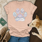 Light pink t-shirt with a paw print featuring winter scenes and animals.