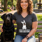 Woman with black lab wearing a t-shirt with a dog graphic and text.