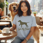 Woman with Golden Retriever wearing "Get My Point" t-shirt at a cafe.